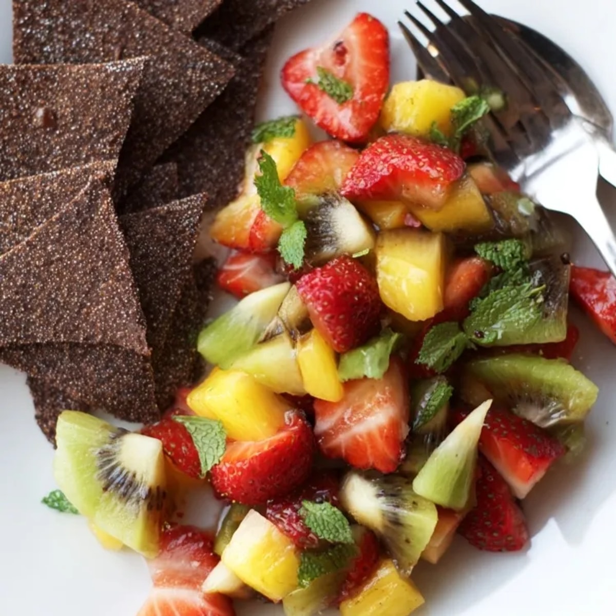 Homemade dessert chips and fruit salsa, a light treat with colorful, juicy flavors.