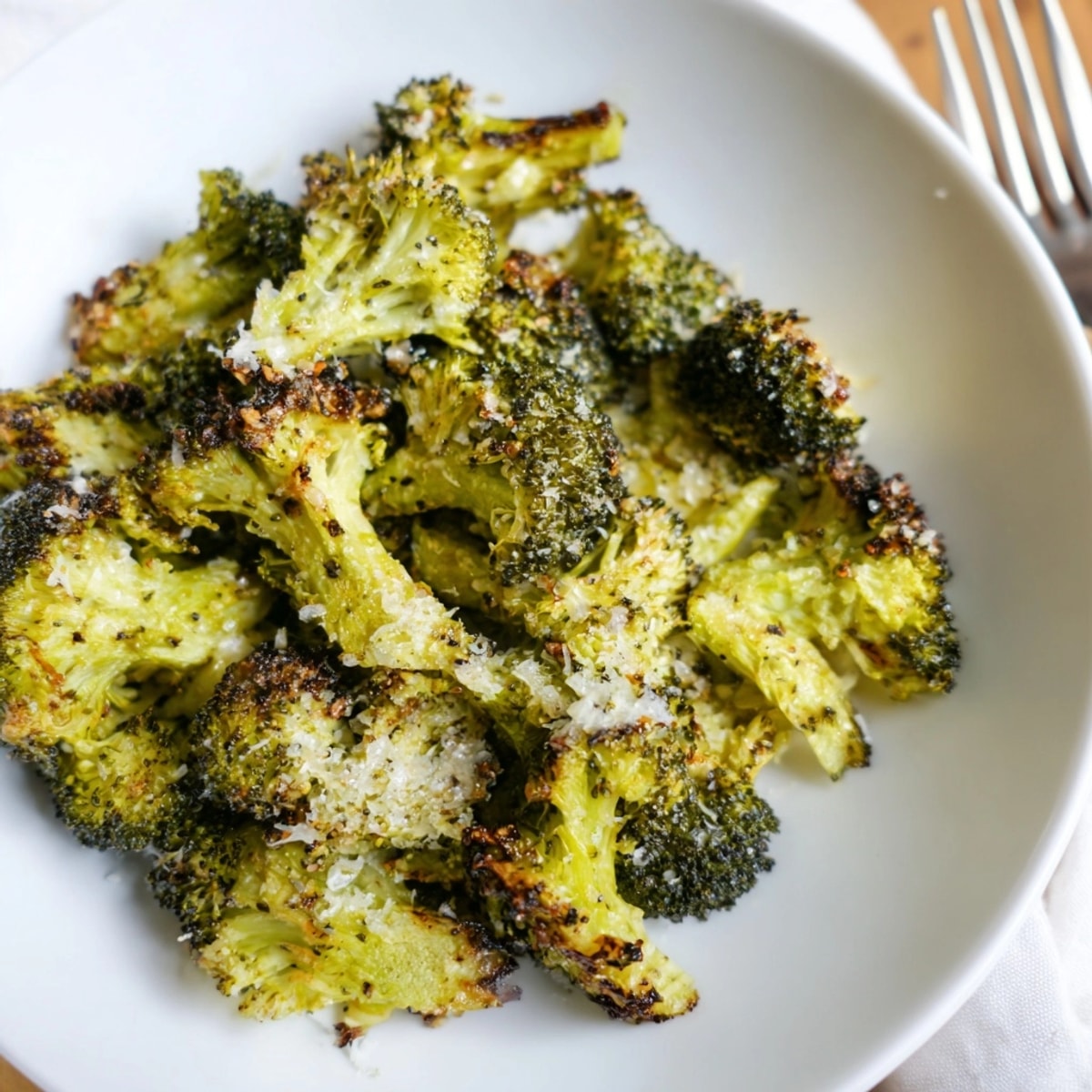 Golden Crispy Parmesan Smashed Broccoli recipe: roasted florets with bubbly, melted cheese topping.