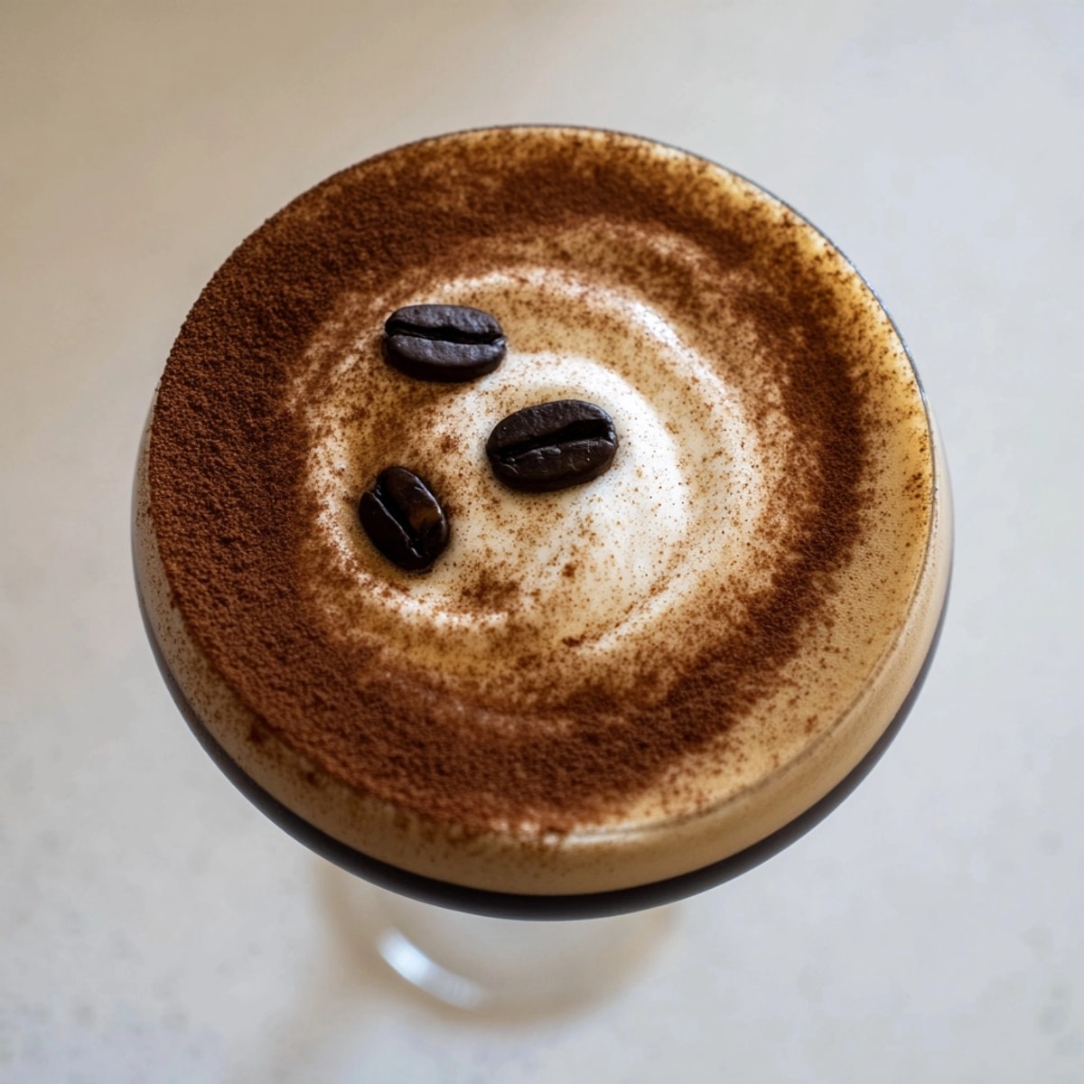 Icy cold Pumpkin Spice Espresso Martini in a glass, ready to enjoy.