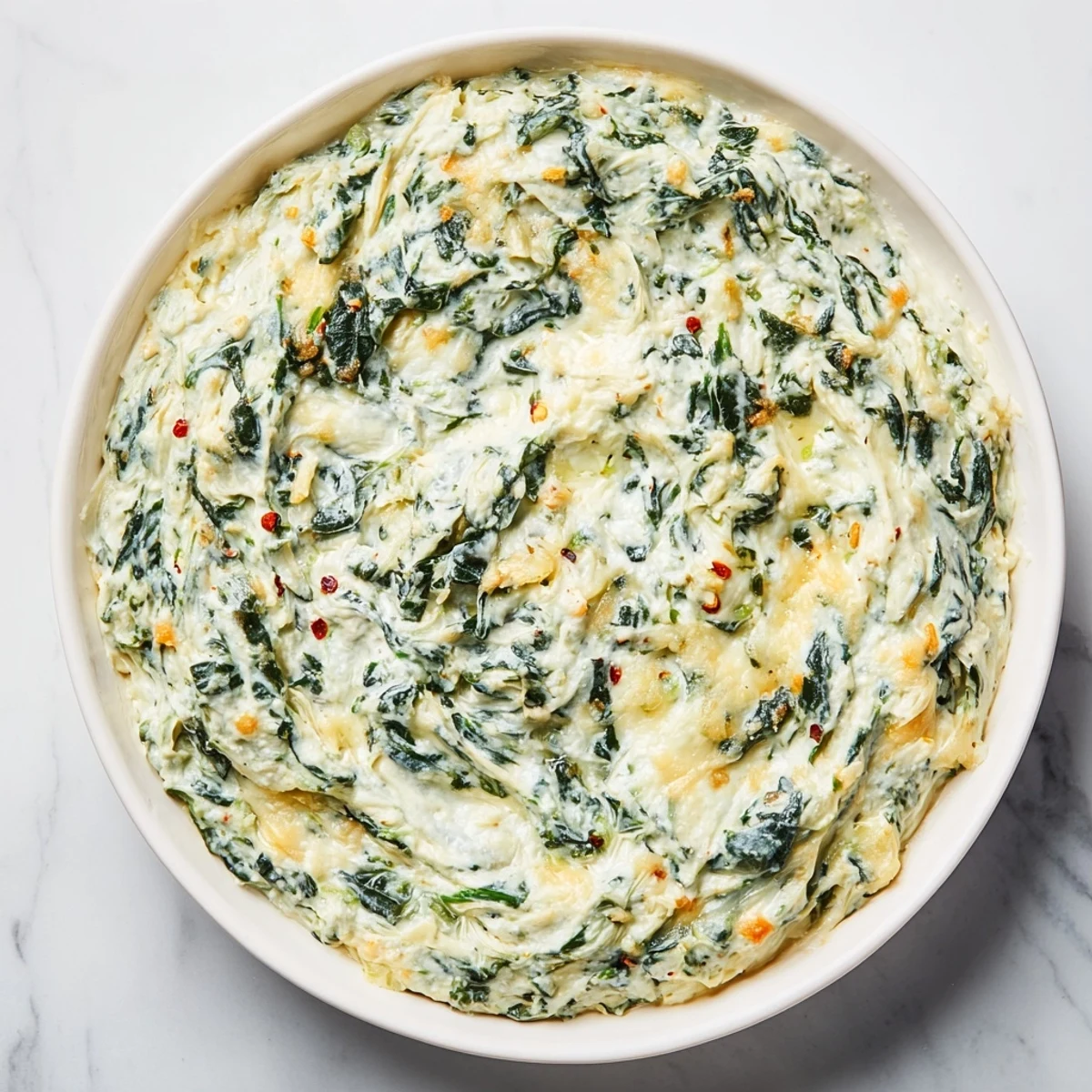 Warm creamy spinach and artichoke dip, bubbly and golden from the oven, ready for dipping.