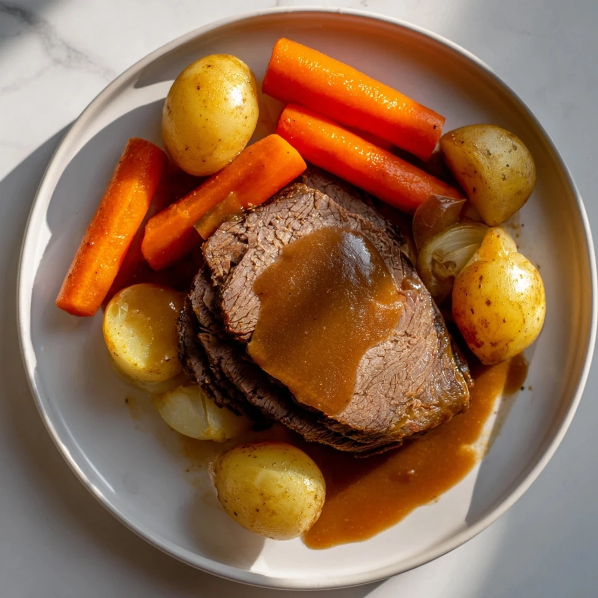 Fork-tender classic beef pot roast with carrots, swimming in a rich, savory gravy, ready to serve.