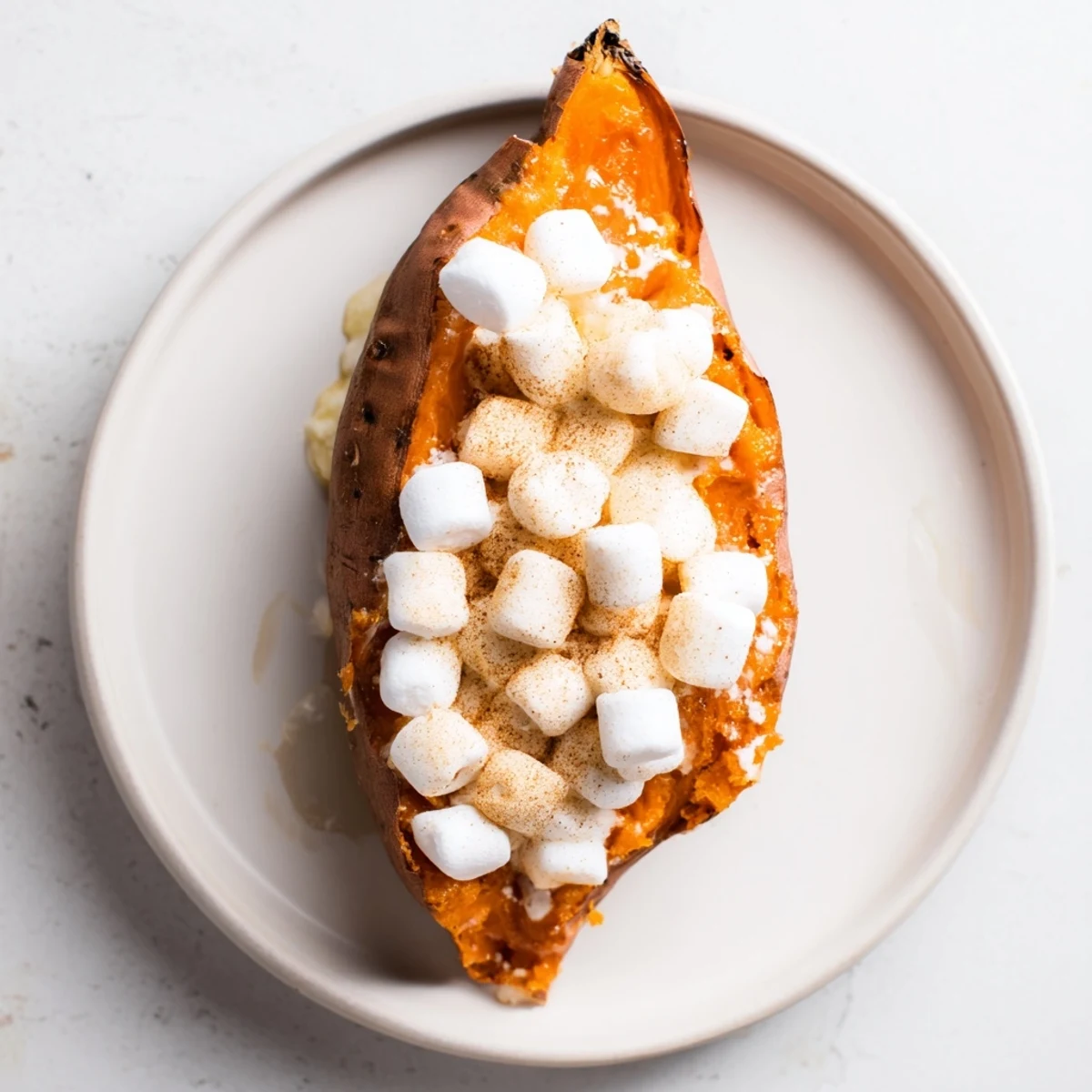 This baked sweet potato with marshmallow recipe shows a comforting side dish perfect for any meal.
