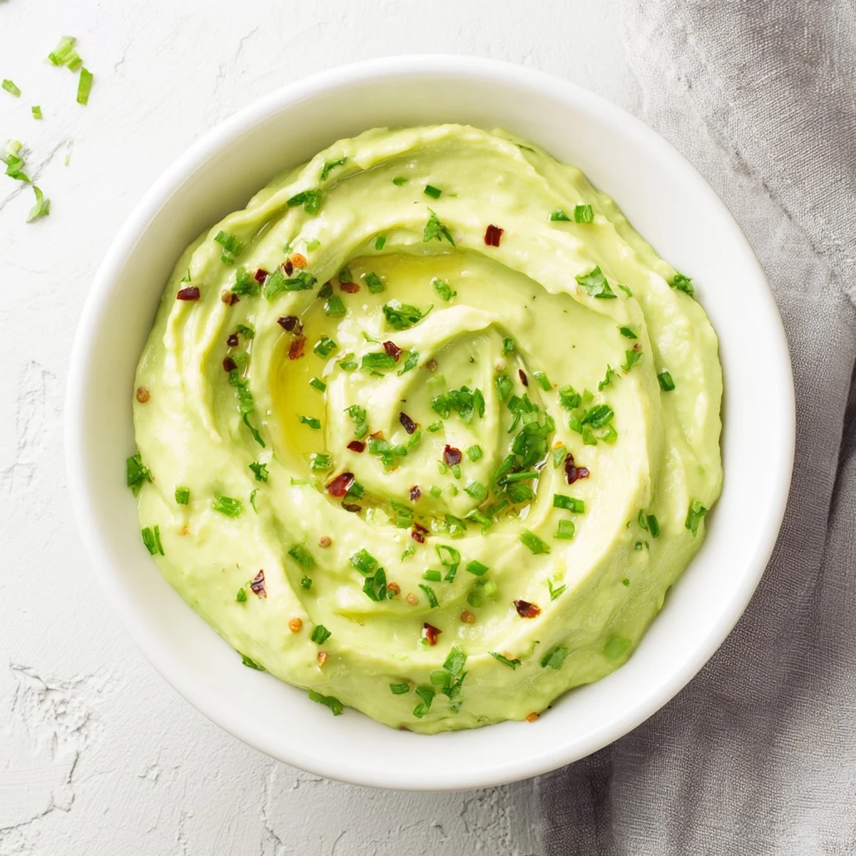 Freshly made Creamy Avocado Lime Dressing, perfectly smooth and thick, ideal for salads or dipping vegetables.