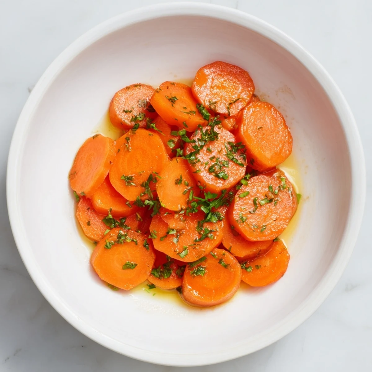 Vibrant orange Glazed Carrots with Maple Syrup glistening, offering a sweet and savory side dish.