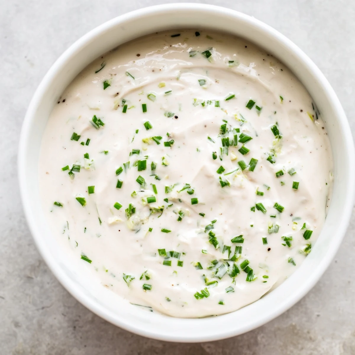 A swirl of the delicious creamy dressing, ideal for topping crisp vegetables with vibrant flavor.