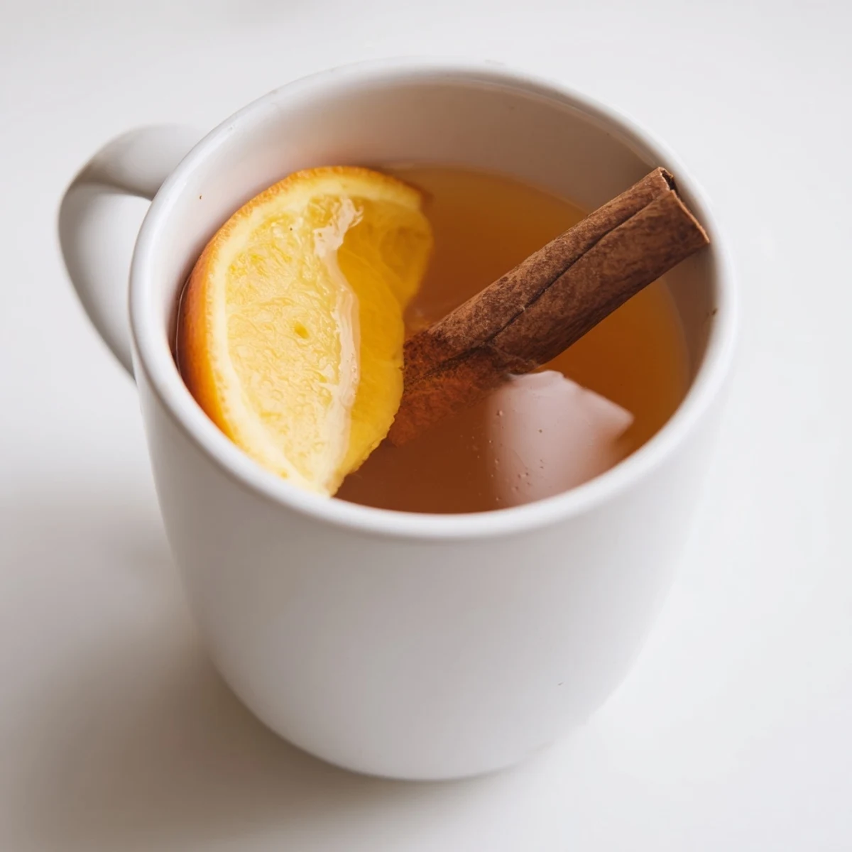 Steaming mugs of cider spiced apple cider, with cinnamon sticks, perfect for fall.