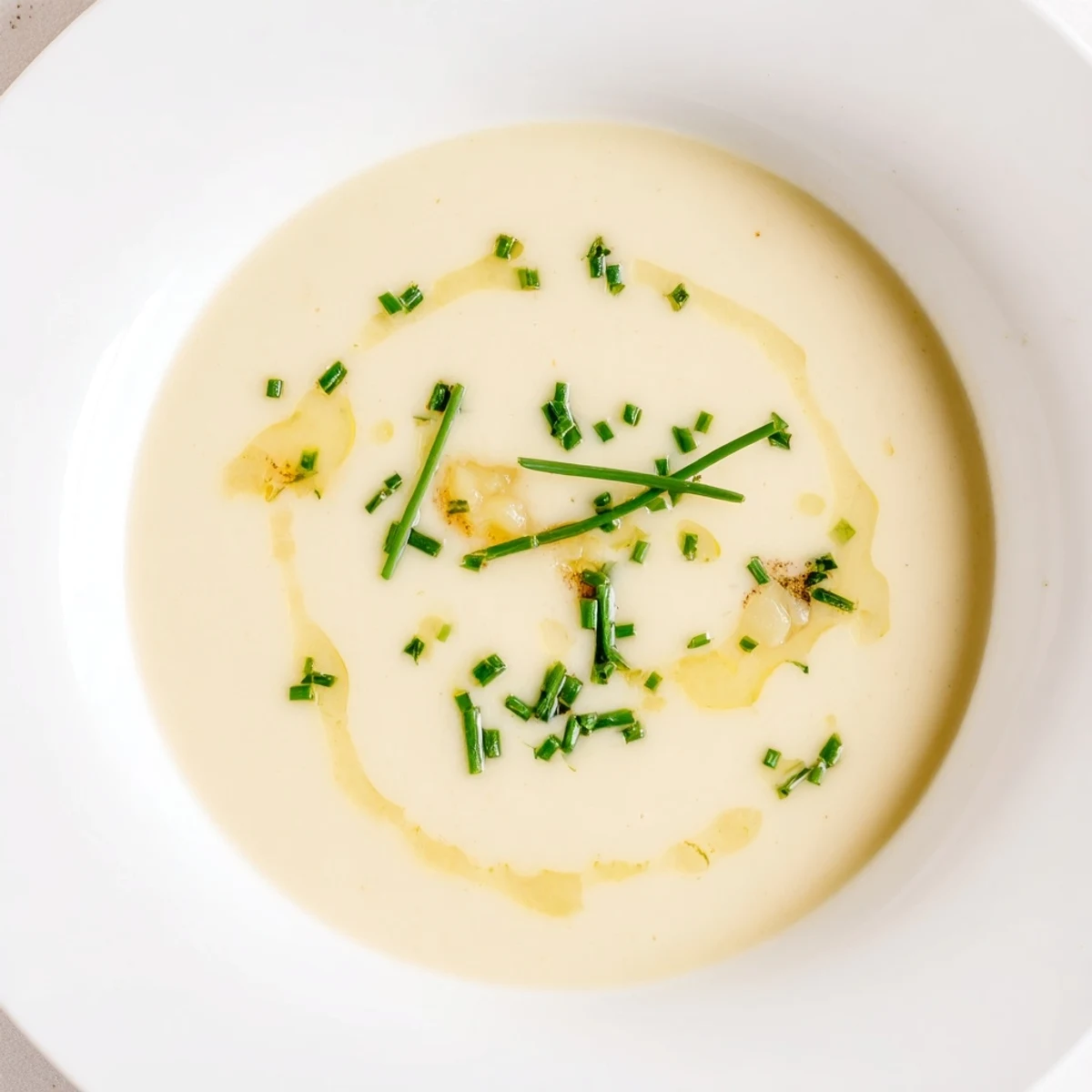 Smooth, blended creamy cauliflower and truffle soup, a gourmet vegetarian delight, ready to serve.