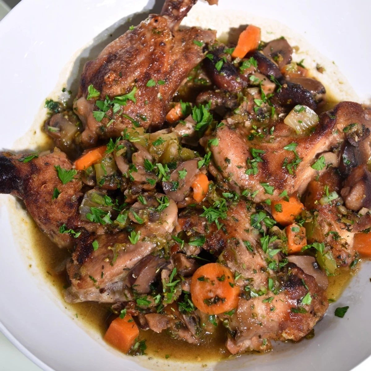 Tender pieces of braised rabbit stew, a hearty meal, with savory vegetables in a rich sauce.