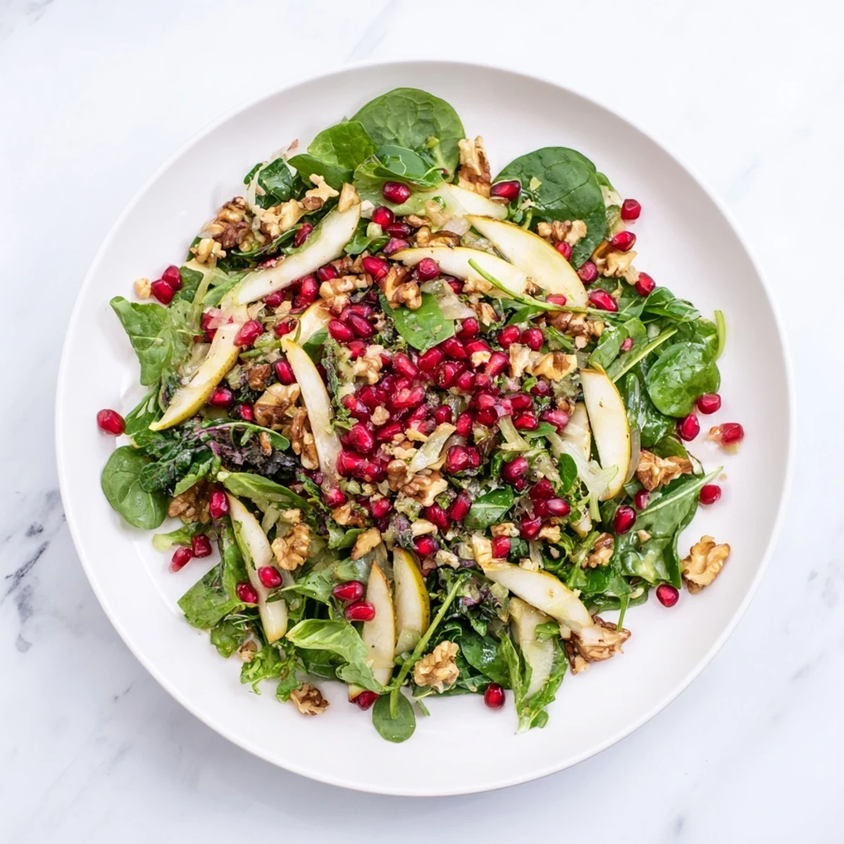 A close-up of a refreshing Winter Salad with Pomegranate, showing juicy fruit and crunchy nuts.