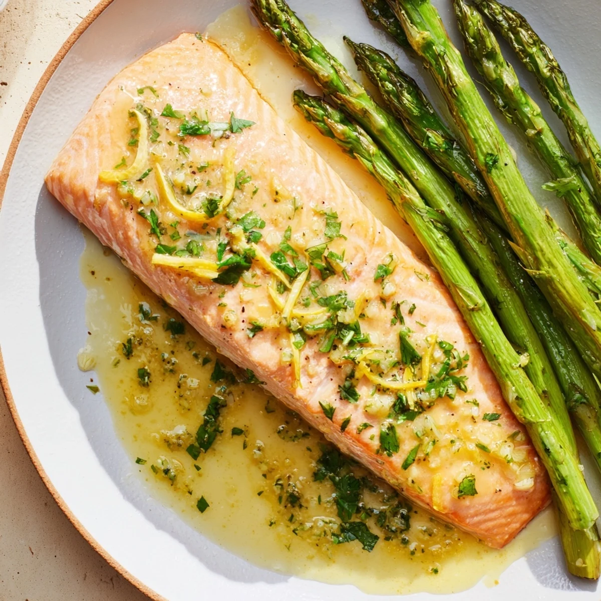 Tender Lemon Garlic Butter Salmon with roasted asparagus ready for a delightful dinner.