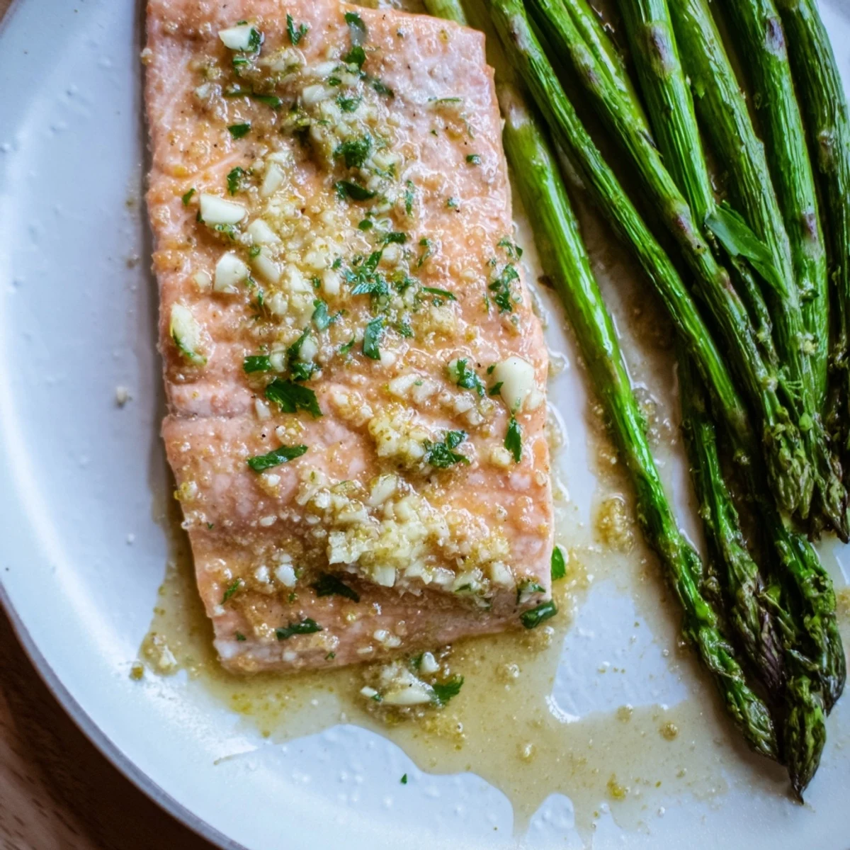 Juicy Lemon Garlic Butter Salmon fillets, baked to perfection with asparagus, perfect for serving.