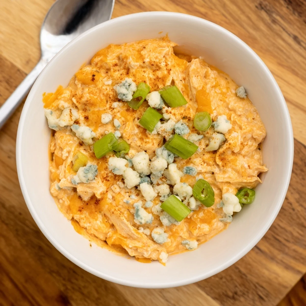 Hot, gooey Touchdown Buffalo Chicken Dip fresh from the oven, paired with crisp tortilla chips and carrot sticks for an easy, crowd-pleasing appetizer.