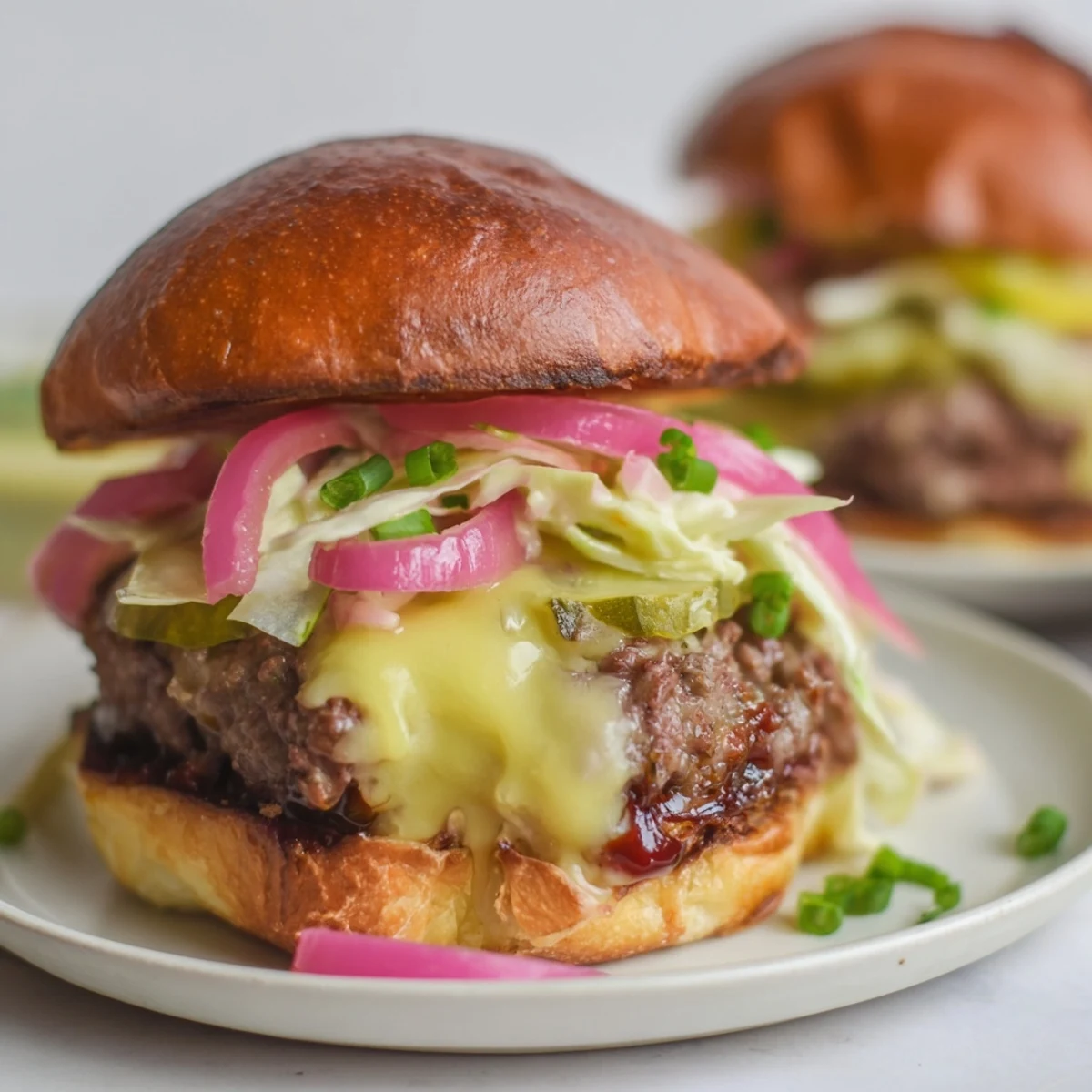 A close-up of grilled Big Game BBQ Beef Sliders on toasted brioche with melted cheese.