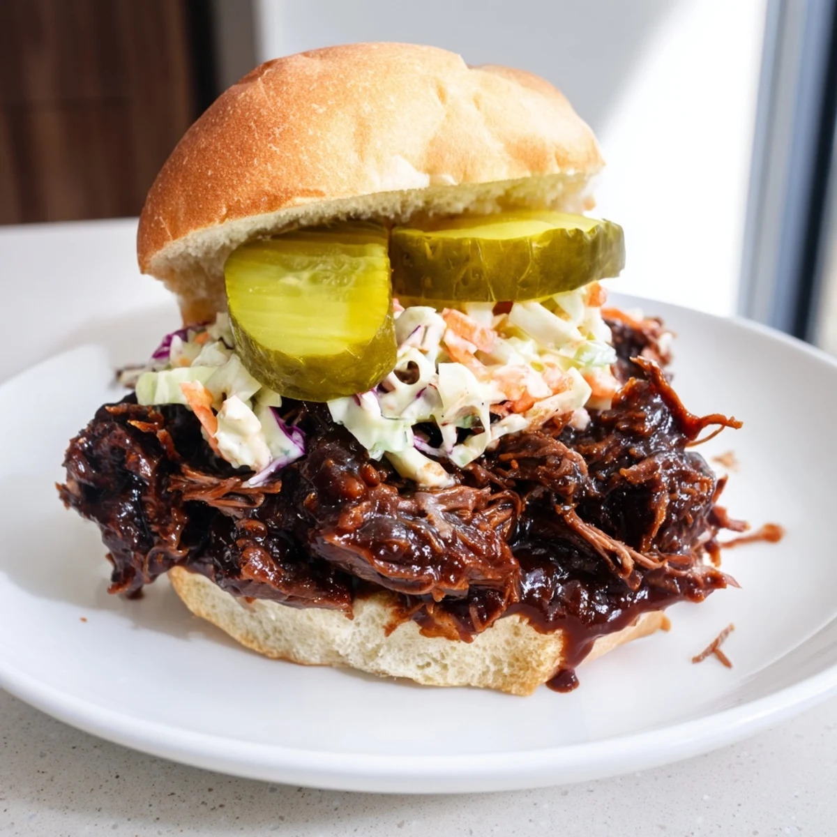 Tender, slow-cooked Beef Brisket Sliders piled high on soft buns, topped with creamy coleslaw and tangy dill pickles for a casual game day meal.