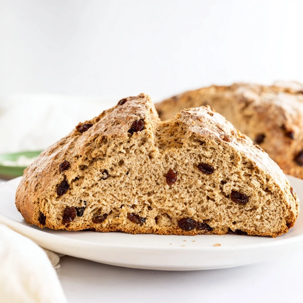 Freshly baked Whole Wheat Irish Soda Bread with Raisins, with a golden crust and moist crumb, ready to slice and serve.