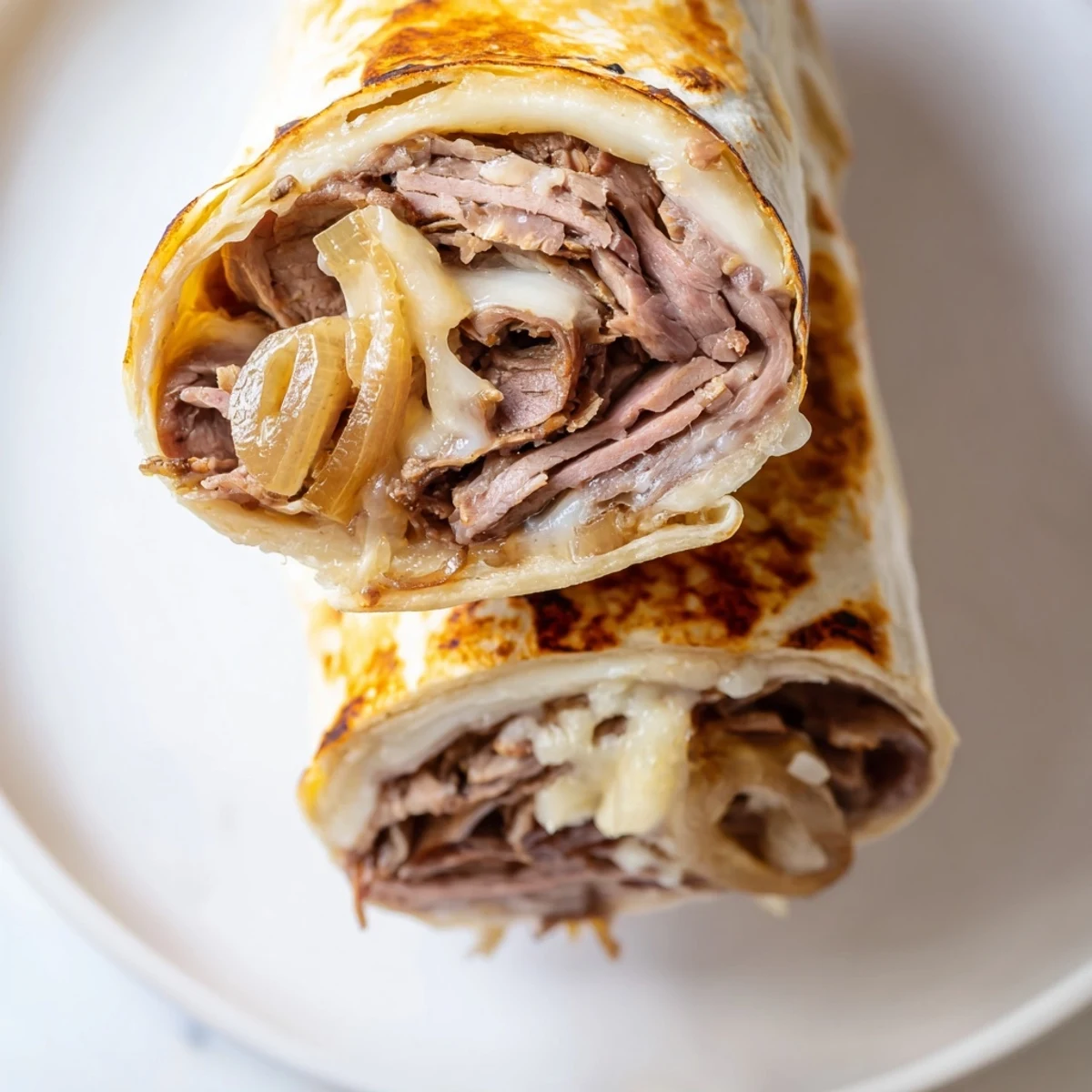 A close-up view shows sliced Easy French Dip Tortilla Roll Ups revealing layers of roast beef and cheese, ready to be dipped.