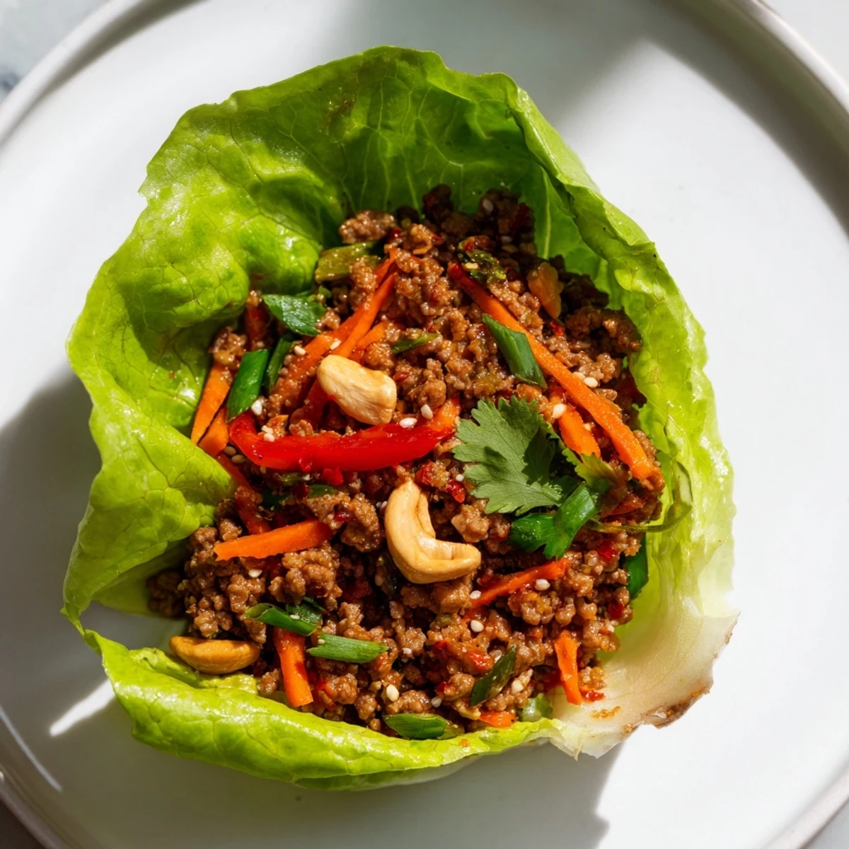 Golden beef and cashew lettuce cups filled with savory seasoned meat and fresh vegetables