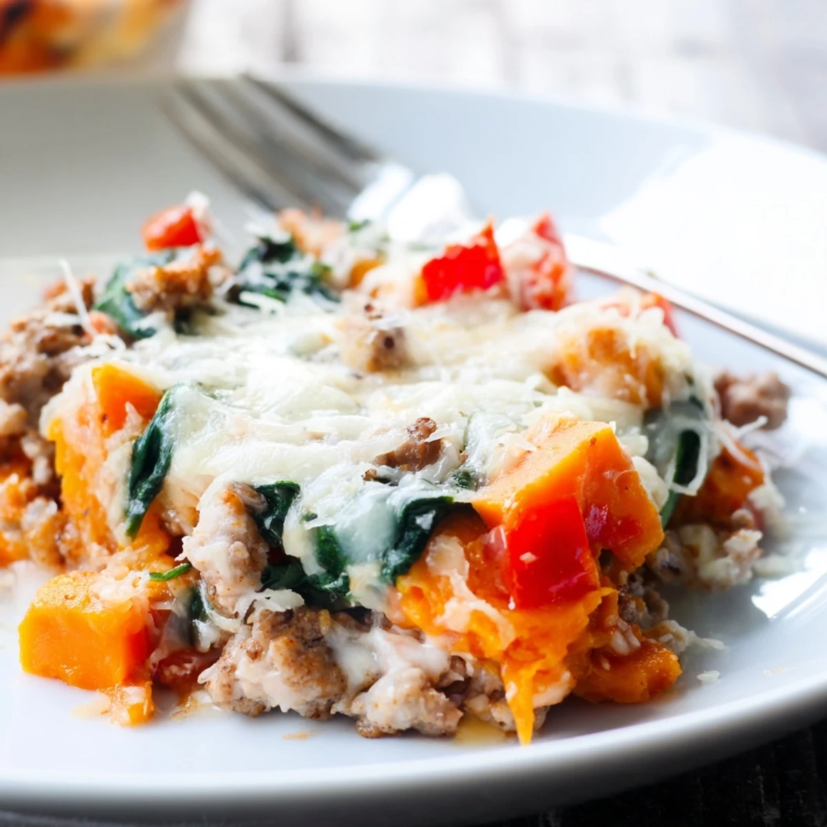 Baked ground turkey sweet potato casserole featuring tender diced vegetables and golden brown cheese crust