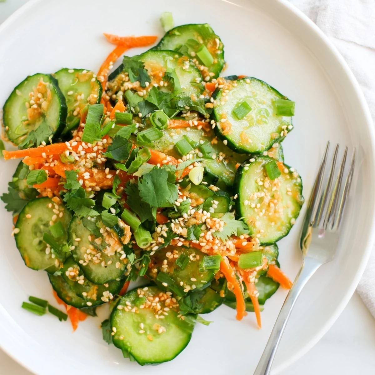 Vibrant bowl of crisp Asian cucumber salad featuring refreshing crunch and zesty sesame ginger dressing