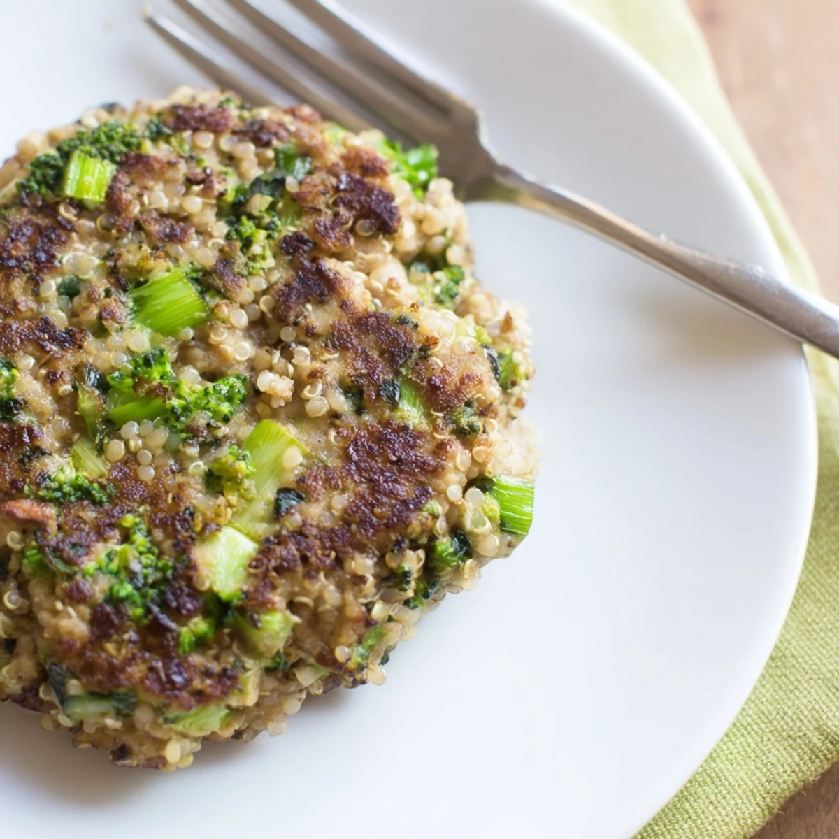 Homemade turkey broccoli and quinoa burgers garnished with fresh parsley and served on gluten-free bun
