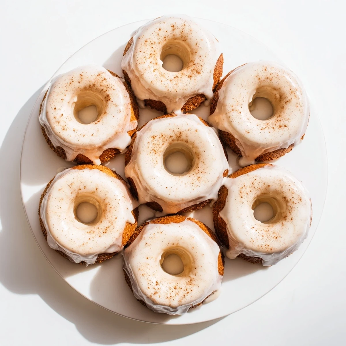 Freshly baked Greek yogurt cake donuts with a glossy vanilla glaze drizzle