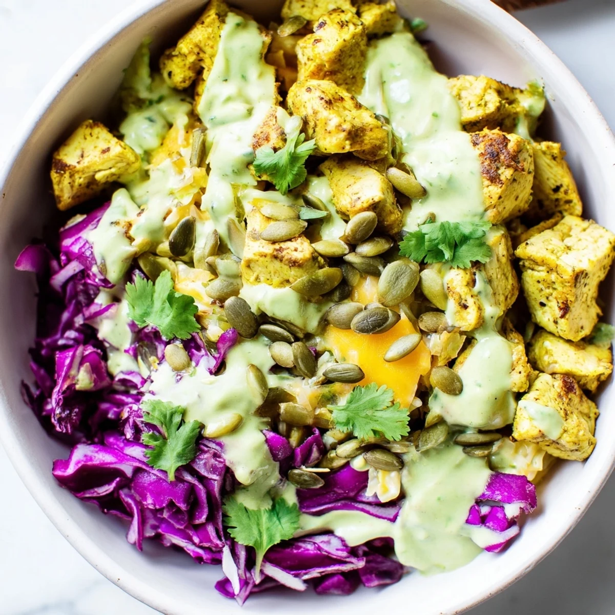 Keto bowls featuring crisp romaine, grilled chicken, and rich avocado dressing drizzle
