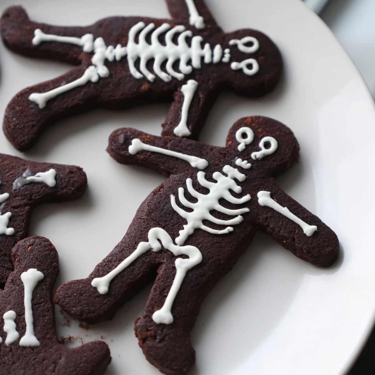 Warm spiced Chocolate Cinnamon Skeleton Cookies arranged on a rustic wooden serving platter