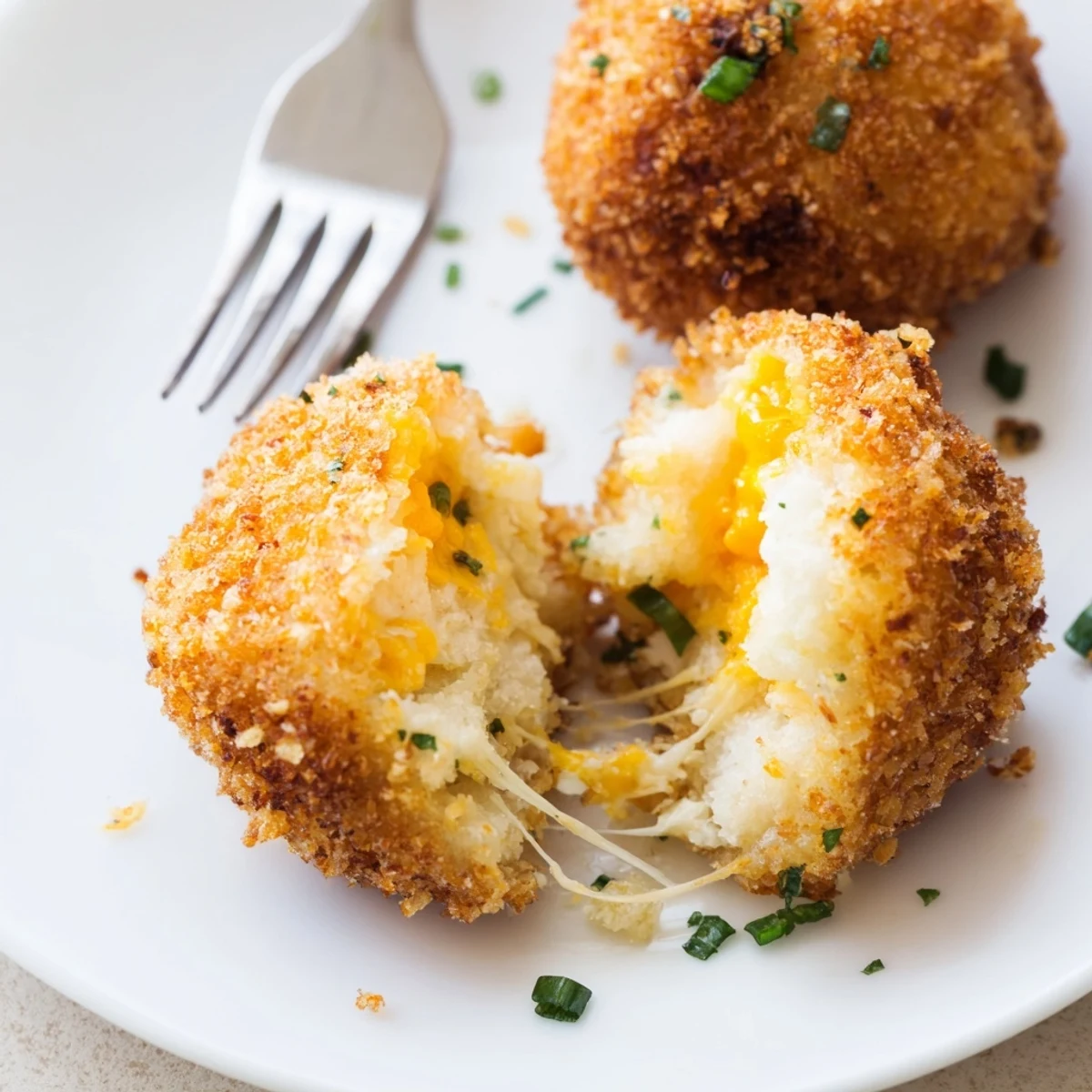Handheld Fried Mashed Potato Balls, crunchy panko crust, warm cheesy interior