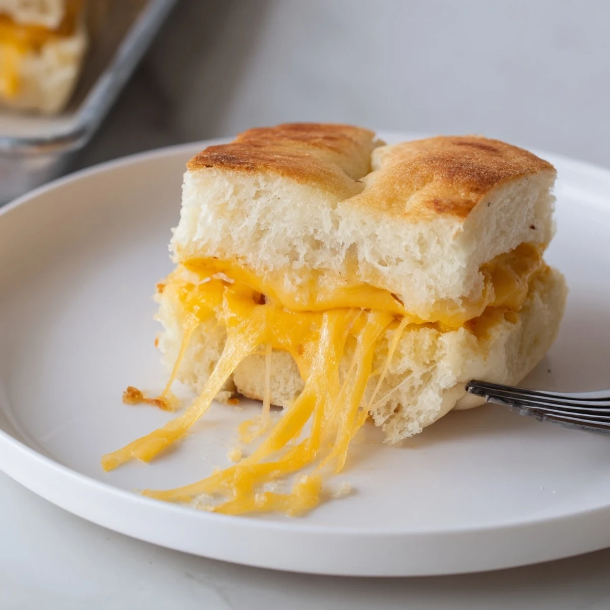 Mini Grilled Cheese Hawaiian Rolls with melted cheddar, golden tops, served warm.