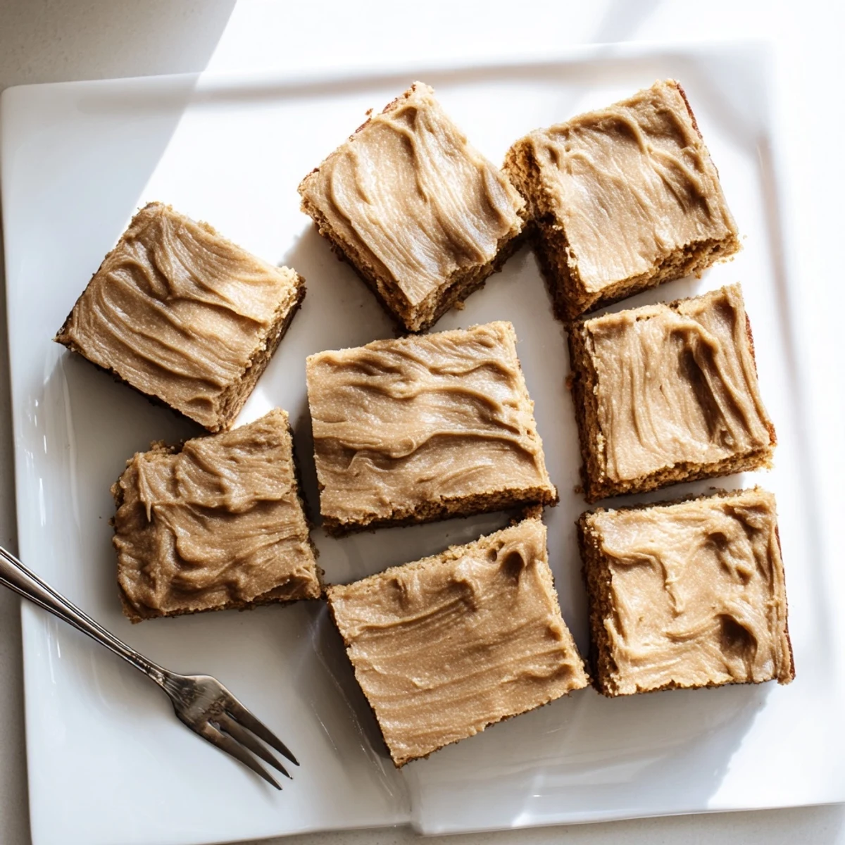 Golden banana bread brownie bars swirled with rich brown butter frosting close up