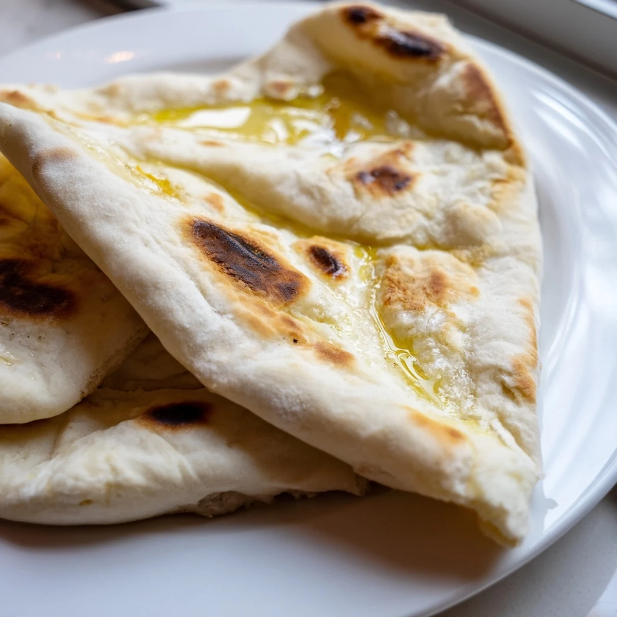 Soft Turkish Bazlama flatbread rounds ready to serve with dips or wraps