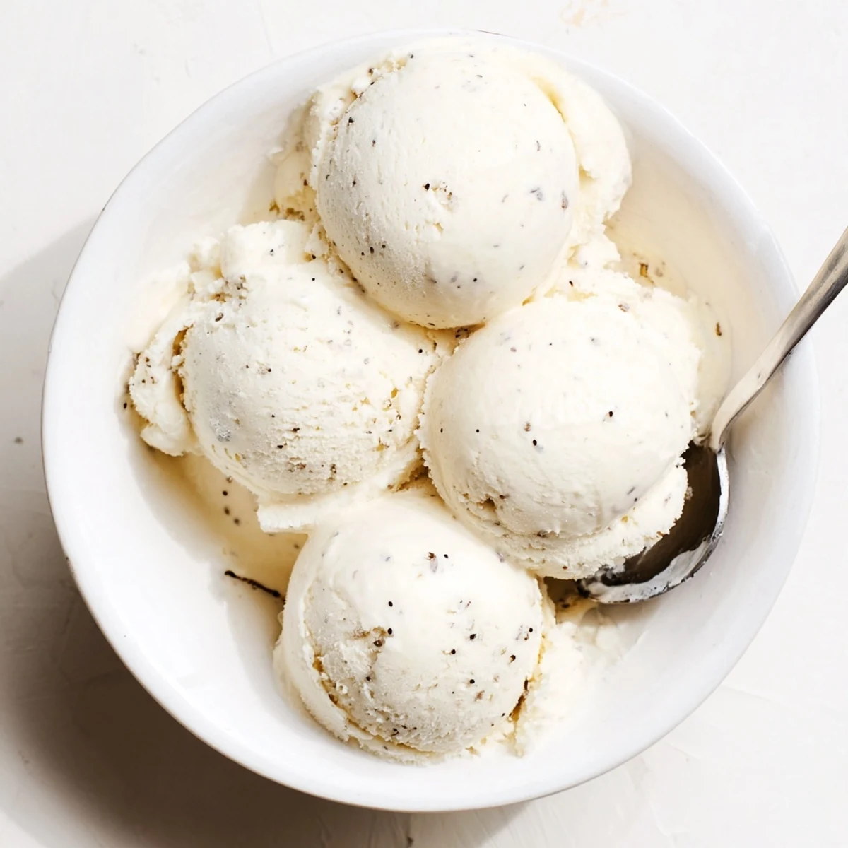 Creamy custard-based vanilla ice cream served in a chilled glass bowl with wafer