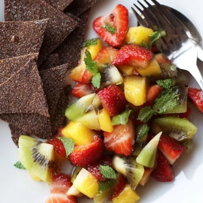 Homemade dessert chips and fruit salsa, a light treat with colorful, juicy flavors.