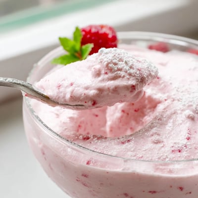 Silky pink Fresh Raspberry Cloud Mousse piped into clear dessert glasses