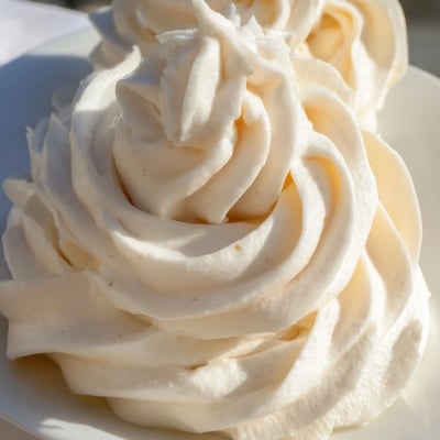 Fluffy Italian Meringue Buttercream spread smoothly over freshly baked cupcakes